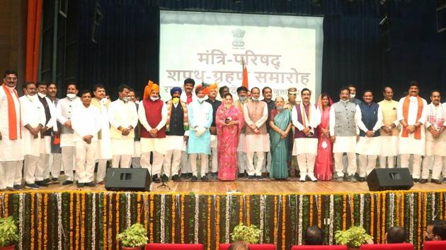 Madhya Pradesh chief minister Shivraj Chouhan is seen with the newly inducted ministers of the State Cabinet after the swearing-in ceremony at Raj Bhawan in Bhopal on Thursday.(PTI Photo) Madhya Pradesh chief minister Shivraj Chouhan is seen with the newly inducted ministers of the State Cabinet after the swearing-in ceremony at Raj Bhawan in Bhopal on Thursday.(PTI Photo)