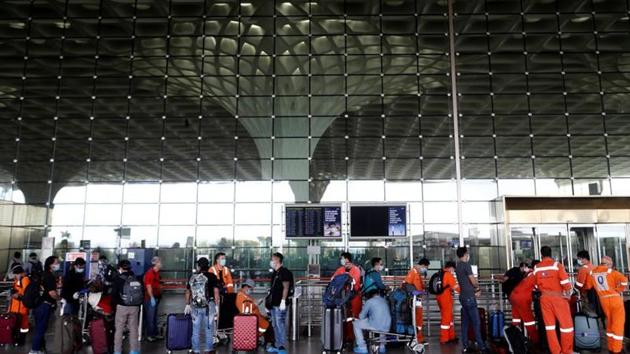 Passengers wearing protective face masks wait in a queue to enter Chhatrapati Shivaji International Airport in Mumbai, India. (REUTERS) Passengers wearing protective face masks wait in a queue to enter Chhatrapati Shivaji International Airport in Mumbai, India. (REUTERS)