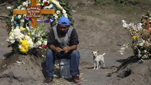 A worker looks on as others dig fresh graves, in a section of the Municipal Cemetery of Valle de Chalco which opened two months ago to accommodate the surge in deaths amid the ongoing coronavirus pandemic, on the outskirts of Mexico City. The country reported a record daily rise of 6,741 confirmed cases, bringing the total to 238,511, according to the Health Ministry. (Rebecca Blackwell / AP) A worker looks on as others dig fresh graves, in a section of the Municipal Cemetery of Valle de Chalco which opened two months ago to accommodate the surge in deaths amid the ongoing coronavirus pandemic, on the outskirts of Mexico City. The country reported a record daily rise of 6,741 confirmed cases, bringing the total to 238,511, according to the Health Ministry. (Rebecca Blackwell / AP)