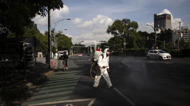 A city worker in protective gear sprays disinfectant near Chapultepec Park in Mexico City on July 1. Deaths rose by 679 to reach a figure of 29, 189 on July 1. The increase in cases comes a day after Mexico overtook Spain to become the country with the world’s sixth deadliest virus outbreak. (Fernando Llano / AP) A city worker in protective gear sprays disinfectant near Chapultepec Park in Mexico City on July 1. Deaths rose by 679 to reach a figure of 29, 189 on July 1. The increase in cases comes a day after Mexico overtook Spain to become the country with the world’s sixth deadliest virus outbreak. (Fernando Llano / AP)