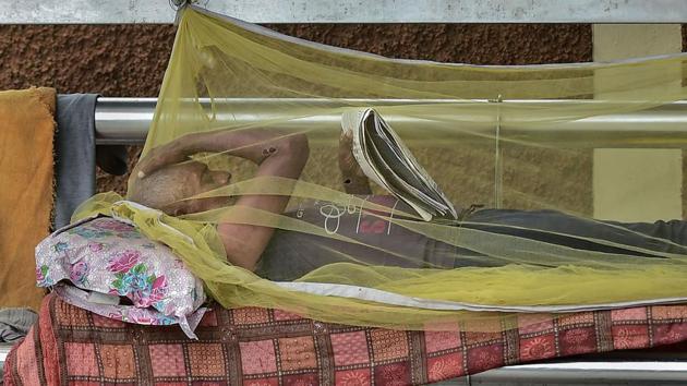A man reads a newspaper while resting inside a mosquito net at a bus stop in Chennai. Between June 19 and June 30, when the state announced a hard lockdown in Chennai, Kancheepuram, Thiruvallur, Madurai and Chengalpattu--327,214 people were tested across the state. Since June 20, there has been a spike in testing, with over 30,000 people tested everyday on average. (R Senthil Kumar / PTI)