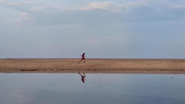 A man runs along the backwaters of Pattinapakkam beach in Chennai. Tamil Nadu said that the lockdown was warranted, as officials found that even symptomatic people were avoiding getting tested because they didn’t want to be in quarantine. Besides this, some reports also suggested that people were also not following norms of social distancing or wearing masks while in public. (R Senthil Kumar / PTI)