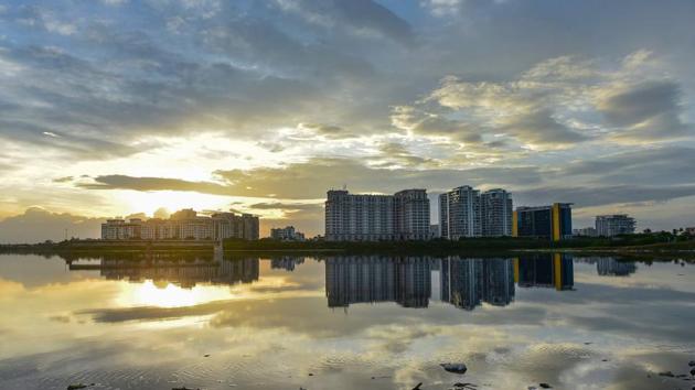 High-rise buildings are reflected in the backwaters of Pattinapakkam beach in Chennai. The Greater Chennai Corporation (GCC) increased fever camps from 300 in May to 520 camps currently across Chennai’s 200 wards. Between May 8 and July 2, a total of 29,051 swabs have been taken at these fever camps and 33,090 people were detected with influenza like illness symptoms. (R Senthil Kumar / PTI)
