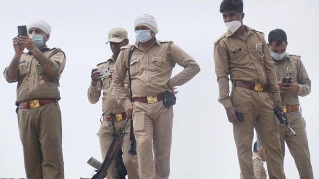 Police personnel at the residence of criminal Vikas Dubey, after an encounter in Bikaru village where 8 police personnel lost their lives, in Kanpur on July 4.(PTI)