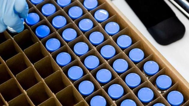 A lab technician loads bright stock filled vials of investigational coronavirus disease (COVID-19) treatment drug remdesivir.(Reuters)