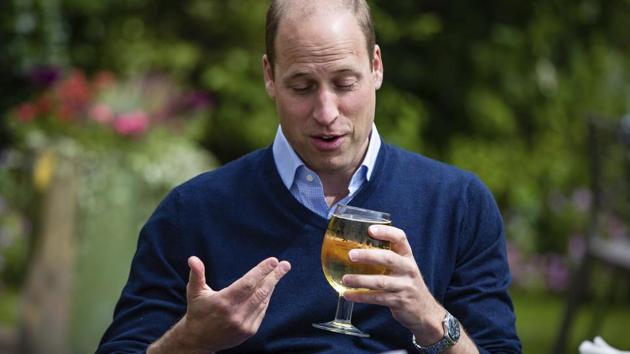 Britain's Prince William drinks cider during a visit to The Rose and Crown pub in Snettisham, England, Friday July 3, 2020. English pubs are among the businesses that are allowed to welcome guests with some anti-virus precautions from Saturday July 4, as the coronavirus restrictions are eased. (AP)