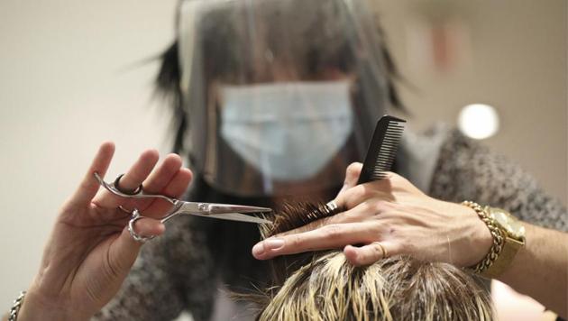 Stylist Tommy D'Amour cuts the hair of client Lea Jantz at Tusk Hair in Camden, London, after opening at midnight to the first post-lockdown customer as restrictions are eased across England early Saturday, July 4, 2020. (AP) Stylist Tommy D'Amour cuts the hair of client Lea Jantz at Tusk Hair in Camden, London, after opening at midnight to the first post-lockdown customer as restrictions are eased across England early Saturday, July 4, 2020. (AP)