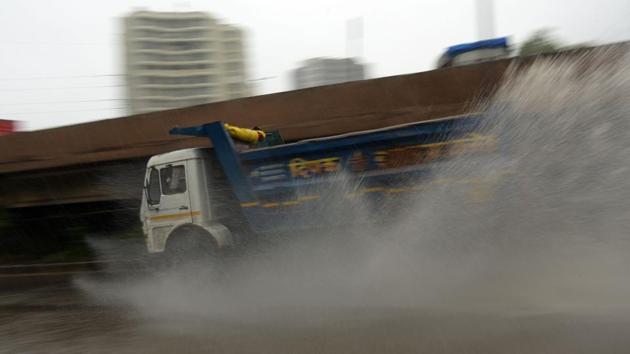 A truck zips through a water logged stretch on the Sion Panvel highway in Navi Mumbai on July 3. Accidents were also recorded due to the season’s first heavy rain yesterday. (Bachchan Kumar / HT Photo) A truck zips through a water logged stretch on the Sion Panvel highway in Navi Mumbai on July 3. Accidents were also recorded due to the season’s first heavy rain yesterday. (Bachchan Kumar / HT Photo)