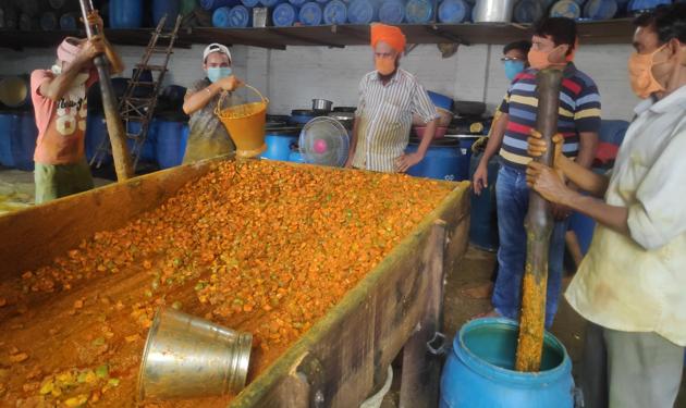 Men at work at a pickle factory in Panipat.(HT Photo)