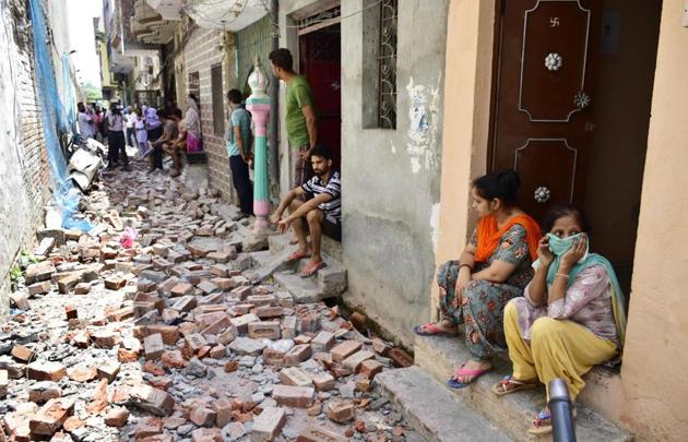 Residents looking at the debris from the wall collapse in Nawankot area on Sunday. As per information, the incident took place around 8pm on Saturday. (Sameer Sehgal/HT) Residents looking at the debris from the wall collapse in Nawankot area on Sunday. As per information, the incident took place around 8pm on Saturday. (Sameer Sehgal/HT)