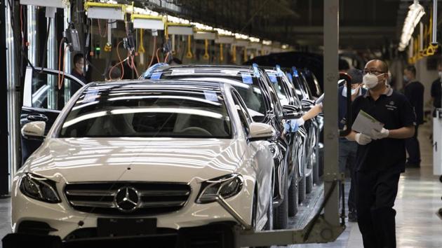 Workers inspect newly assembled cars at a Beijing Benz Automotive Co. Ltd factory, a German joint venture company for Mercedes-Benz, in Beijing on Wednesday, May 13, 2020. (AP) Workers inspect newly assembled cars at a Beijing Benz Automotive Co. Ltd factory, a German joint venture company for Mercedes-Benz, in Beijing on Wednesday, May 13, 2020. (AP)