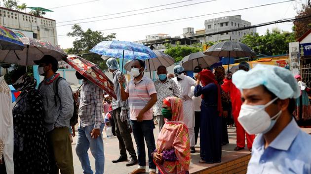 The piece of genome that the study found is responsible for the infection, is common in those living in Bangladesh. People are seen here waiting in the queue outside of a Covid-19 testing centre in Dhaka.(Reuters File Photo) The piece of genome that the study found is responsible for the infection, is common in those living in Bangladesh. People are seen here waiting in the queue outside of a Covid-19 testing centre in Dhaka.(Reuters File Photo)