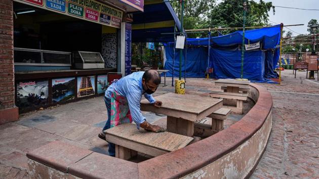 A worker at a food stall cleans while setting up at Dilli Haat in New Delhi on July 4. The usually bustling Dilli Haat in INA reopened on the July 4 weekend after more than three months to barely any visitors. Even several store operators kept away. At its eateries, most owners told HT that their employees had returned to their home states. (Biplov Bhuyan / HT PHOTO) A worker at a food stall cleans while setting up at Dilli Haat in New Delhi on July 4. The usually bustling Dilli Haat in INA reopened on the July 4 weekend after more than three months to barely any visitors. Even several store operators kept away. At its eateries, most owners told HT that their employees had returned to their home states. (Biplov Bhuyan / HT PHOTO)
