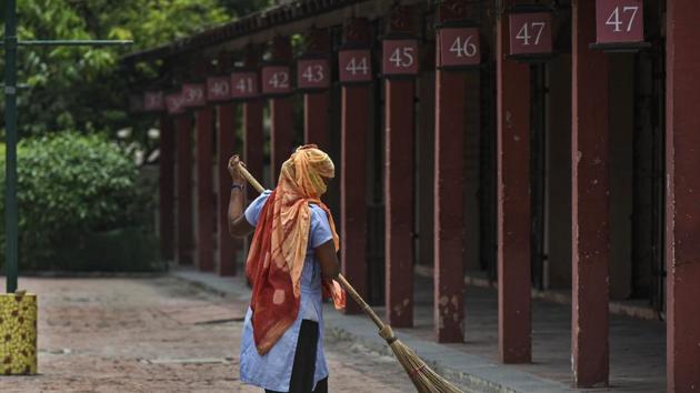 A worker cleans the premises at Dilli Haat ahead of its reopening in New Delhi, India, on July 4, 2020.(Biplov Bhuyan/HT Photo)