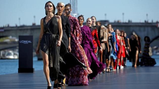 Models present creations on a giant catwalk installed on a barge on the Seine River during a public event organized by L'Oreal as part of Paris Fashion Week, France, September 30, 2018.(REUTERS/Stephane Mahe/File Photo)