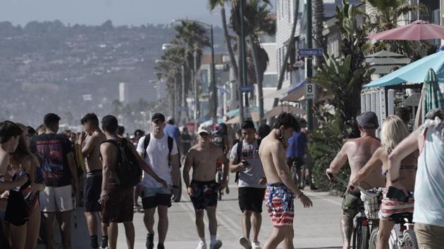 People crowd the Mission Beach boardwalk in San Diego, California, US. (Bloomberg) People crowd the Mission Beach boardwalk in San Diego, California, US. (Bloomberg)