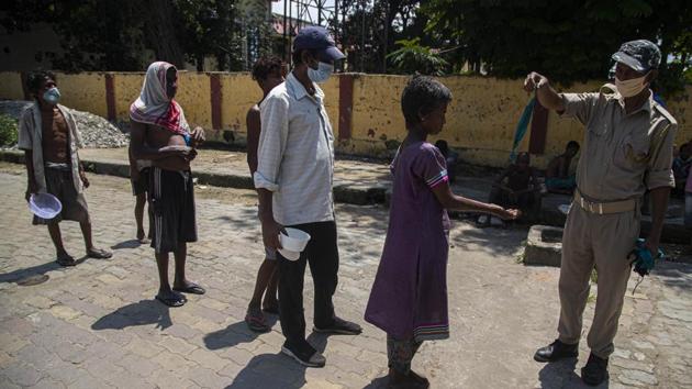 An Assam police officer distributes free face masks to homeless people in Gauhati, India, Saturday, July 4, 2020. (AP photo) An Assam police officer distributes free face masks to homeless people in Gauhati, India, Saturday, July 4, 2020. (AP photo)