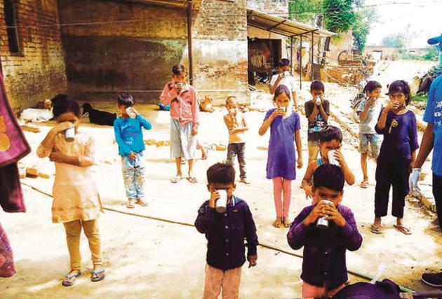 Children in a village near Lucknow drinking free goat milk. (ht) Children in a village near Lucknow drinking free goat milk. (ht)