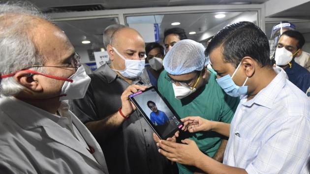 Delhi chief minister Arvind Kejriwal speaks with a person via video call during a visit to the Rajiv Gandhi Super Specialty Hospital at Dilshad Garden, in New Delhi. (Sonu Mehta/HT PHOTO) Delhi chief minister Arvind Kejriwal speaks with a person via video call during a visit to the Rajiv Gandhi Super Specialty Hospital at Dilshad Garden, in New Delhi. (Sonu Mehta/HT PHOTO)