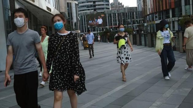People wearing face masks are seen at the Sanlitun shopping area, following the outbreak of the coronavirus disease (Covid-19) in Beijing, China.(Reuters Photo/Representative Image) People wearing face masks are seen at the Sanlitun shopping area, following the outbreak of the coronavirus disease (Covid-19) in Beijing, China.(Reuters Photo/Representative Image)