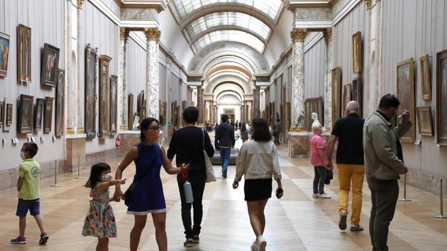 People wearing face masks visit the Louvre Museum in Paris on July 6. Some 70% of the Louvre’s 9.6 million visitors last year were from overseas, and with tourism at a standstill, Martinez told AFP that numbers could drop sharply. “We are going to be at best 20 to 30% down on last summer -- between 4,000 and 10,000 visitors a day,” he estimated. (FRANCOIS GUILLOT / AFP) People wearing face masks visit the Louvre Museum in Paris on July 6. Some 70% of the Louvre’s 9.6 million visitors last year were from overseas, and with tourism at a standstill, Martinez told AFP that numbers could drop sharply. “We are going to be at best 20 to 30% down on last summer -- between 4,000 and 10,000 visitors a day,” he estimated. (FRANCOIS GUILLOT / AFP)