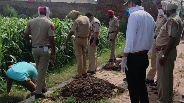Cops check the murder spot and nearby areas for clues in Kalalmajra village in Khanna on Monday. (HT Photo) Cops check the murder spot and nearby areas for clues in Kalalmajra village in Khanna on Monday. (HT Photo)