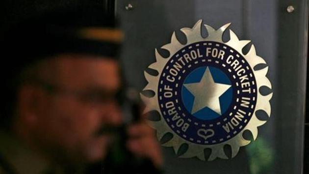 A policeman walks past a logo of the Board of Control for Cricket in India (BCCI).(REUTERS)