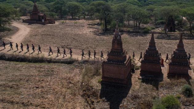 Members of a police squad seen patrolling a temple complex in Bagan, Myanmar in late June. Armed police have been combing the ancient city of Bagan, a UNESCO World Heritage site that is strewn with centuries old temples, pagodas and numerous other monuments, as intruders seek to turn coronavirus imposed restrictions to their advantage and make away with priceless relics. (Ye Aung Thu / AFP) Members of a police squad seen patrolling a temple complex in Bagan, Myanmar in late June. Armed police have been combing the ancient city of Bagan, a UNESCO World Heritage site that is strewn with centuries old temples, pagodas and numerous other monuments, as intruders seek to turn coronavirus imposed restrictions to their advantage and make away with priceless relics. (Ye Aung Thu / AFP)