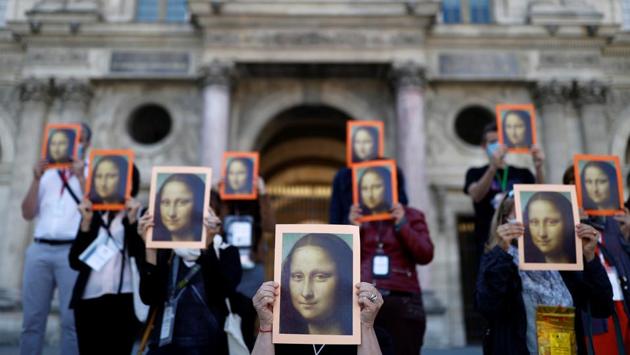 Paris tour guides hold posters depicting the Mona Lisa by artist Leonardo da Vinci during a demonstration at the Louvre museum courtyard to draw attention towards their working conditions in Paris as the museum reopened its doors, in France on July 6. (Christian Hartmann / REUTERS) Paris tour guides hold posters depicting the Mona Lisa by artist Leonardo da Vinci during a demonstration at the Louvre museum courtyard to draw attention towards their working conditions in Paris as the museum reopened its doors, in France on July 6. (Christian Hartmann / REUTERS)