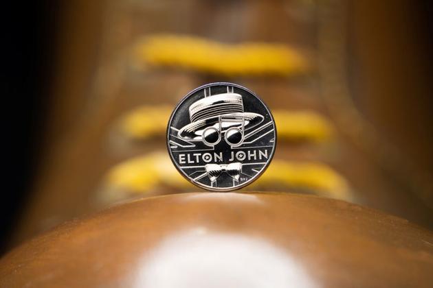 The coin sits on top of the boots worn by Elton John, acting as the Pinball Wizard in the musical film 'Tommy' in 1975, from the new competitive Elton John coin collection released by Britain's Royal Mint. (via REUTERS) The coin sits on top of the boots worn by Elton John, acting as the Pinball Wizard in the musical film 'Tommy' in 1975, from the new competitive Elton John coin collection released by Britain's Royal Mint. (via REUTERS)
