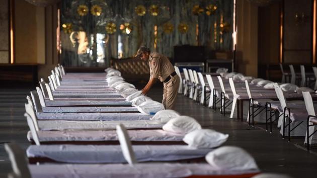 A home guard arranges beds in the hall of Heritage Grand Banquet which has been requisitioned for use as a care facility for coronavirus patients in New Delhi on July 5. The World Health Organization (WHO) reported a record single-day increase of 212,326 global coronavirus cases on July 4. On July 5, India overtook Russia to become the third worst-hit country. (Sanchit Khanna / HT Photo) A home guard arranges beds in the hall of Heritage Grand Banquet which has been requisitioned for use as a care facility for coronavirus patients in New Delhi on July 5. The World Health Organization (WHO) reported a record single-day increase of 212,326 global coronavirus cases on July 4. On July 5, India overtook Russia to become the third worst-hit country. (Sanchit Khanna / HT Photo)