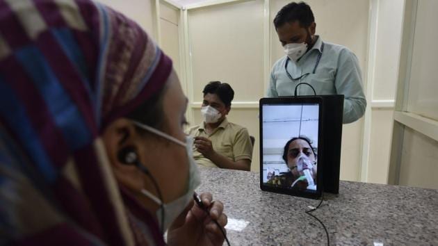 A family member talks to a relative admitted for COVID-19 treatment using video conferencing facilities at LNJP hospital on July 3. Delhi has also seen increase in its recovery rate over recent weeks. The number of recoveries shot up June 18 onwards when 3,884 people recovered or were discharged in one day, rather than the few hundred per day previously. (Vipin Kumar / HT Photo) A family member talks to a relative admitted for COVID-19 treatment using video conferencing facilities at LNJP hospital on July 3. Delhi has also seen increase in its recovery rate over recent weeks. The number of recoveries shot up June 18 onwards when 3,884 people recovered or were discharged in one day, rather than the few hundred per day previously. (Vipin Kumar / HT Photo)
