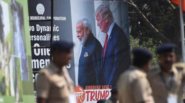Policemen stand in front of a billboard displaying a picture of Prime Minister Narendra Modi and US President Donald Trump in Ahmedabad on February 23, 2020, ahead of Trump's arrival.(AFP)