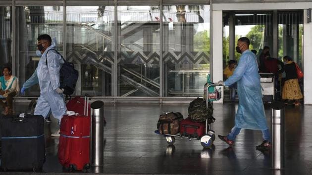 Travellers in PPE coveralls at the Netaji Subhas Chandra Bose International Airport in Kolkata, on Monday. (Samir Jana/HT Photo) Travellers in PPE coveralls at the Netaji Subhas Chandra Bose International Airport in Kolkata, on Monday. (Samir Jana/HT Photo)
