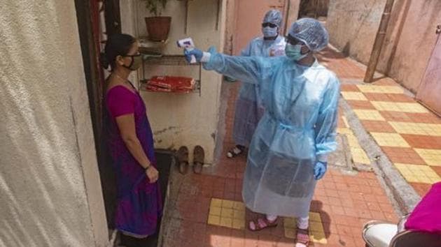Health workers thermal screen a woman during a door to door screening for coronavirus in a slum near Dandekar bridge in Pune, Maharashtra. (Pratham Gokhale/HT file photo) Health workers thermal screen a woman during a door to door screening for coronavirus in a slum near Dandekar bridge in Pune, Maharashtra. (Pratham Gokhale/HT file photo)