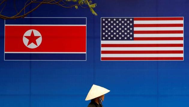 A person walks past a banner showing North Korean and U.S. flags ahead of the North Korea-U.S. summit in Hanoi, Vietnam.(REUTERS)