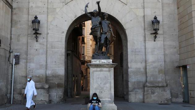 A woman wearing a face mask sits under a statue after Catalonia’s government imposed new restrictions to control the coronavirus outbreak in Lleida, Spain on July 4. A lockdown was ordered in northwestern Spain, restricting travel in and out for about 70,000 residents. (Nacho Doce / REUTERS) A woman wearing a face mask sits under a statue after Catalonia’s government imposed new restrictions to control the coronavirus outbreak in Lleida, Spain on July 4. A lockdown was ordered in northwestern Spain, restricting travel in and out for about 70,000 residents. (Nacho Doce / REUTERS)