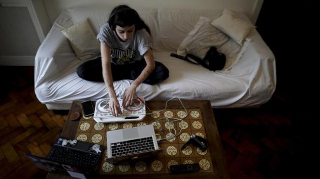 Deflina Espina plays music at home during a government-ordered lockdown to curb the spread of the new coronavirus in Buenos Aires, Argentina. (AP) Deflina Espina plays music at home during a government-ordered lockdown to curb the spread of the new coronavirus in Buenos Aires, Argentina. (AP)