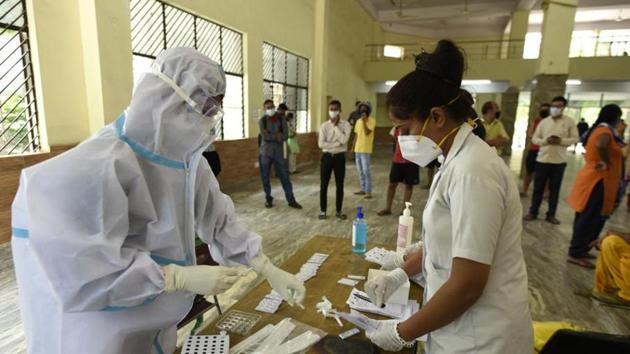 A health worker in PPE kit conducts rapid antigen Covid-19 tests, at Sukhrali Village Community Centre, in Gurugram. (Parveen Kumar/ Hindustan Times) A health worker in PPE kit conducts rapid antigen Covid-19 tests, at Sukhrali Village Community Centre, in Gurugram. (Parveen Kumar/ Hindustan Times)