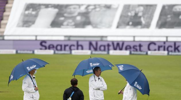 Umpires hold umbrellas as rain delayed start of the first day of the 1st cricket Test match between England and West Indies, at the Ageas Bowl in Southampton, England, Wednesday July 8, 2020. (Adrian Dennis/Pool via AP)(AP)
