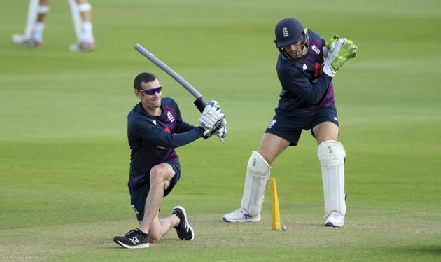 England wicketkeeper Jos Buttler, right, takes part in a drill with coach Chris Read during a nets session at the Ageas Bowl in Southampton, England, Tuesday July 7, 2020. England are scheduled to play West Indies in their first Test match on July 8-12. (Stu Forster/Agency Pool)(AP)