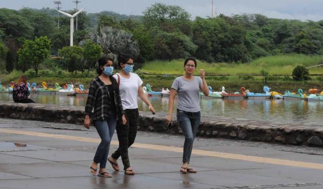 Women enjoying a stroll at the Sukhna Lake in Chandigarh on a rainy Wednesday.(Keshav Singh/HT)