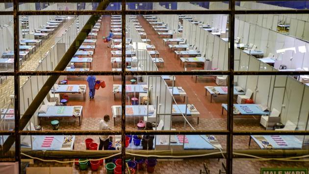 Health workers during preparation work at CWG Village COVID centre, amid Unlock 2.0, near Akshardham in New Delhi. (PTI) Health workers during preparation work at CWG Village COVID centre, amid Unlock 2.0, near Akshardham in New Delhi. (PTI)
