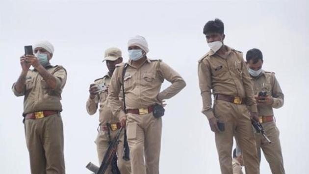 Kanpur: Police personnel at the residence of criminal Vikas Dubey after an encounter in Bikaru village where 8 police personnel lost their lives, in Kanpur, Saturday.(PTI)