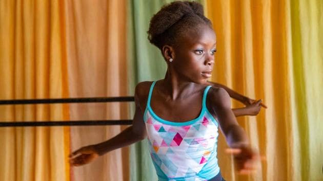 Chinemere Duru (L) practices a pirouette at the academy. “In this area, I know we can’t actually afford the luxury of ballet, or dance education -- so I think it’s a beautiful art to introduce to our people here,” Daniel Ajala told AFP. (Benson Ibeabuchi / AFP)