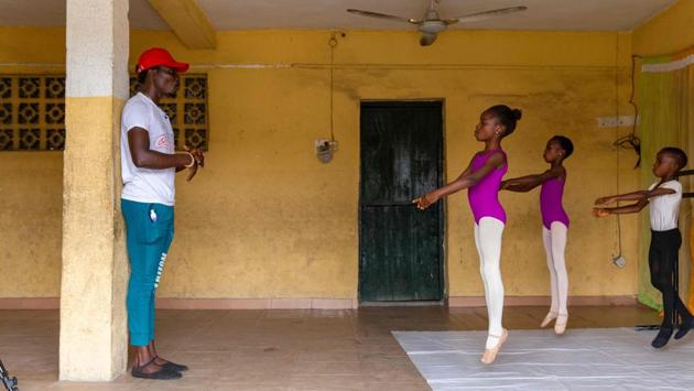 Self-taught dance tutor Daniel Ajala (L) shows students ballet stretch routines during rehearsals in Ajangbadi, Lagos on July 3. Operating in a spare room at a run-down primary school with patches of damp on the walls, this is the Leap of Dance Academy. (Benson Ibeabuchi / AFP)