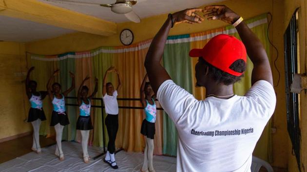 Daniel Ajala (R) demonstrates a ballet stretch during rehearsals at Leap of Dance Academy on July 3. The school is the brainchild of Ajala, who opened its doors in late 2017 after studying the dance moves online and in books. Now the academy, which Ajala funds out of his own pocket, has 12 pupils aged between six and 15. (Benson Ibeabuchi / AFP)