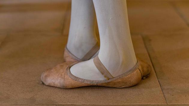 A student maintains the fifth position in ballet at the Leap of Dance Academy on July 3. The lessons are free and shoes and kit provided to the children, most of whom had never heard of ballet before they got involved. (Benson Ibeabuchi / AFP)