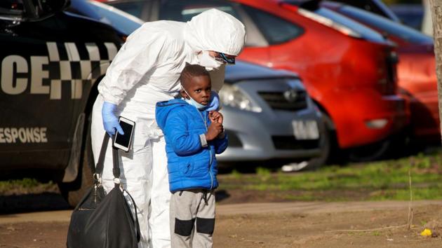 A support worker comforts a young child after he was separated from his mother. The announcement of lockdown brought rushed evacuations on both sides of the border. “We’ve had a mass evacuation of Victorians,” Ray Bell, owner of the Twofold Bay Motor Inn in Eden, told Reuters. (Sandra Sanders / REUTERS) 