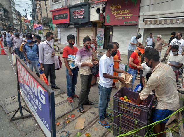 People stand in a queue to buy vegetables from a mobile vendor, during total lockdown, in Guwahati, Wednesday, July 8, 2020. (PTI) People stand in a queue to buy vegetables from a mobile vendor, during total lockdown, in Guwahati, Wednesday, July 8, 2020. (PTI)